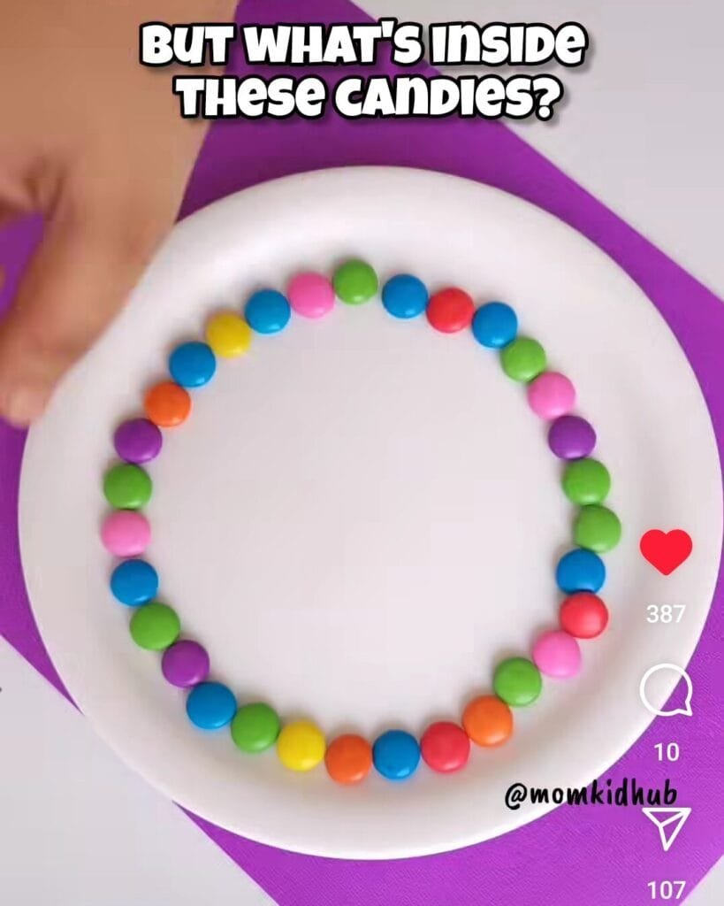 M&M and GEMS candies arranged in circle on white plate for science experiment