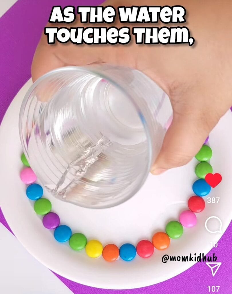 Pouring warm water into center of M&M candy science experiment